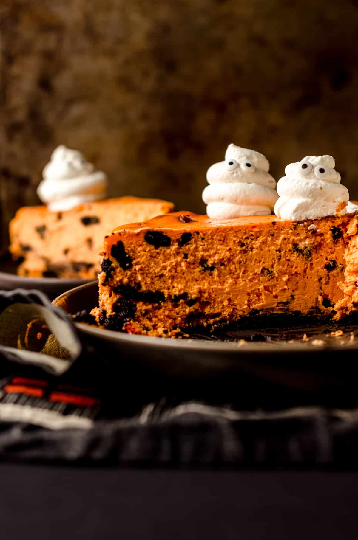 sliced halloween cheesecake with whipped cream ghosts