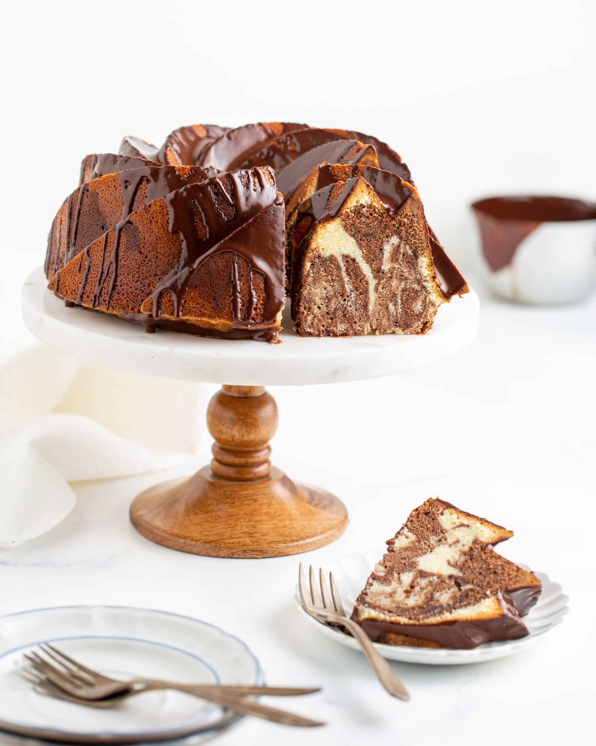 marble pound cake baked in a bundt pan on a cake stand