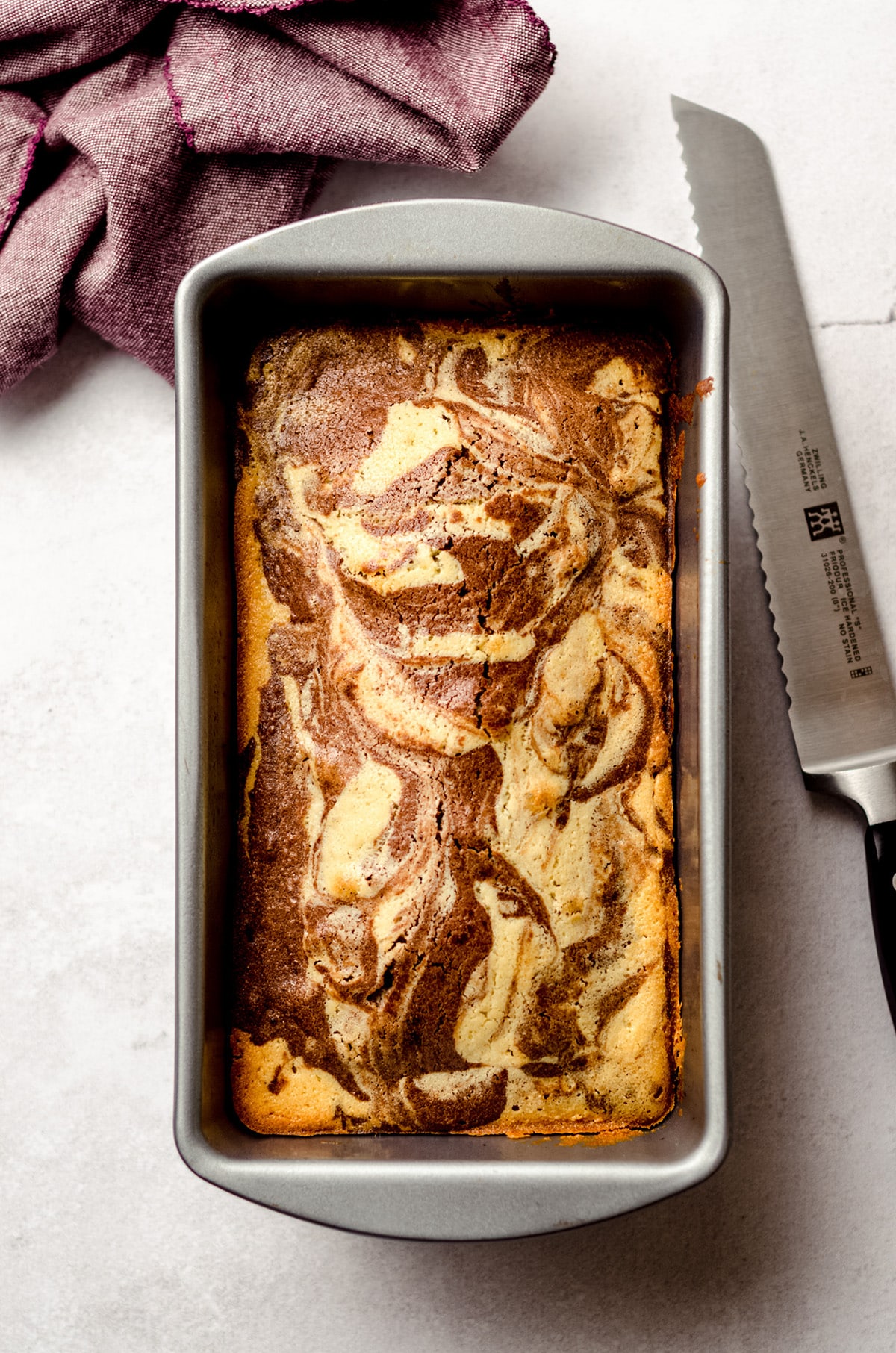a loaf of marble pound cake baked in a pan