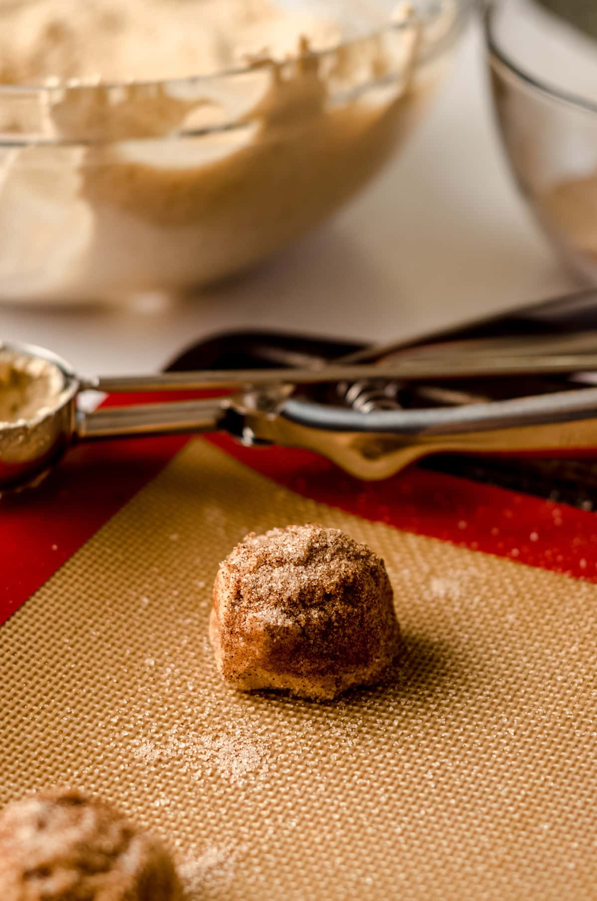 snickerdoodle cookie dough balls on a baking sheet