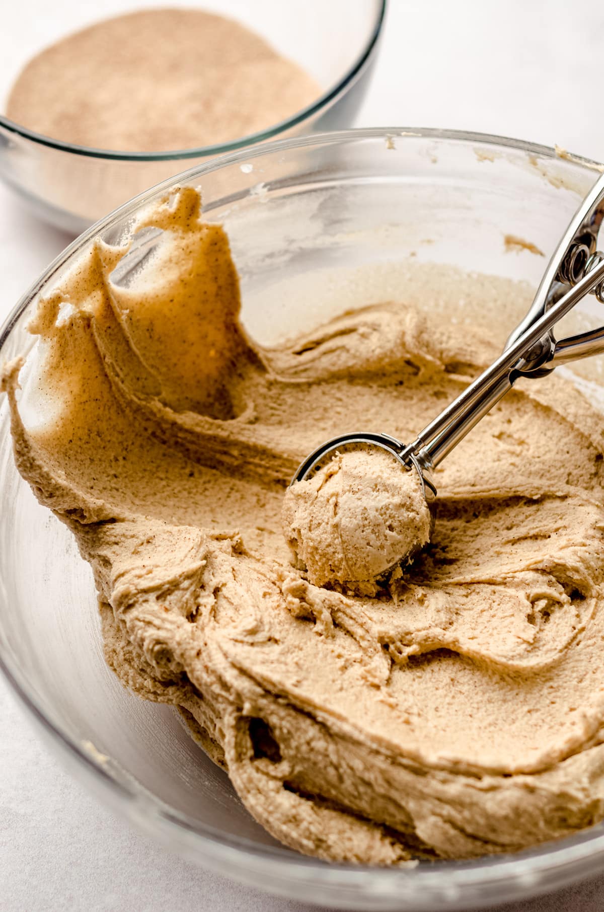 scooping snickerdoodle cookie dough with a cookie scoop