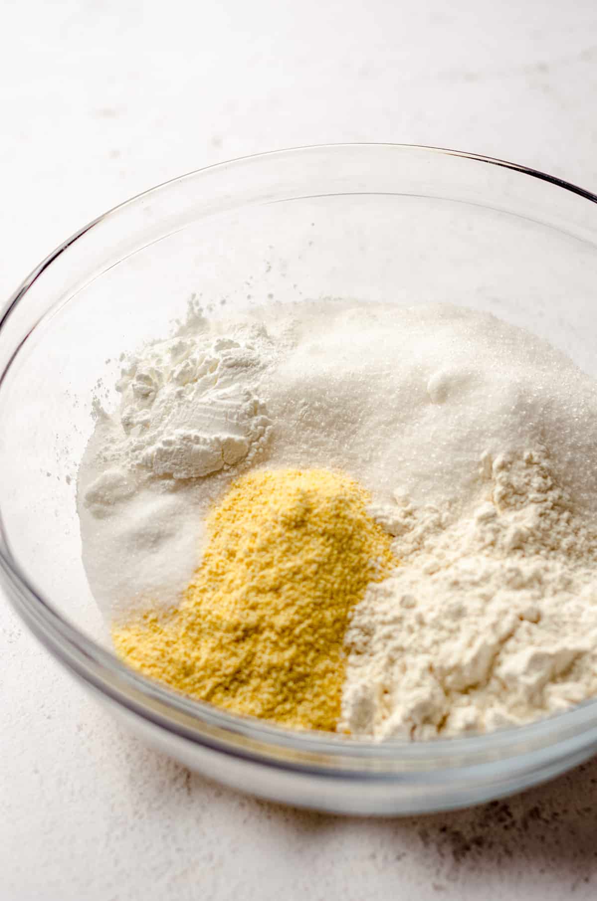 ingredients for homemade cornbread in a glass bowl