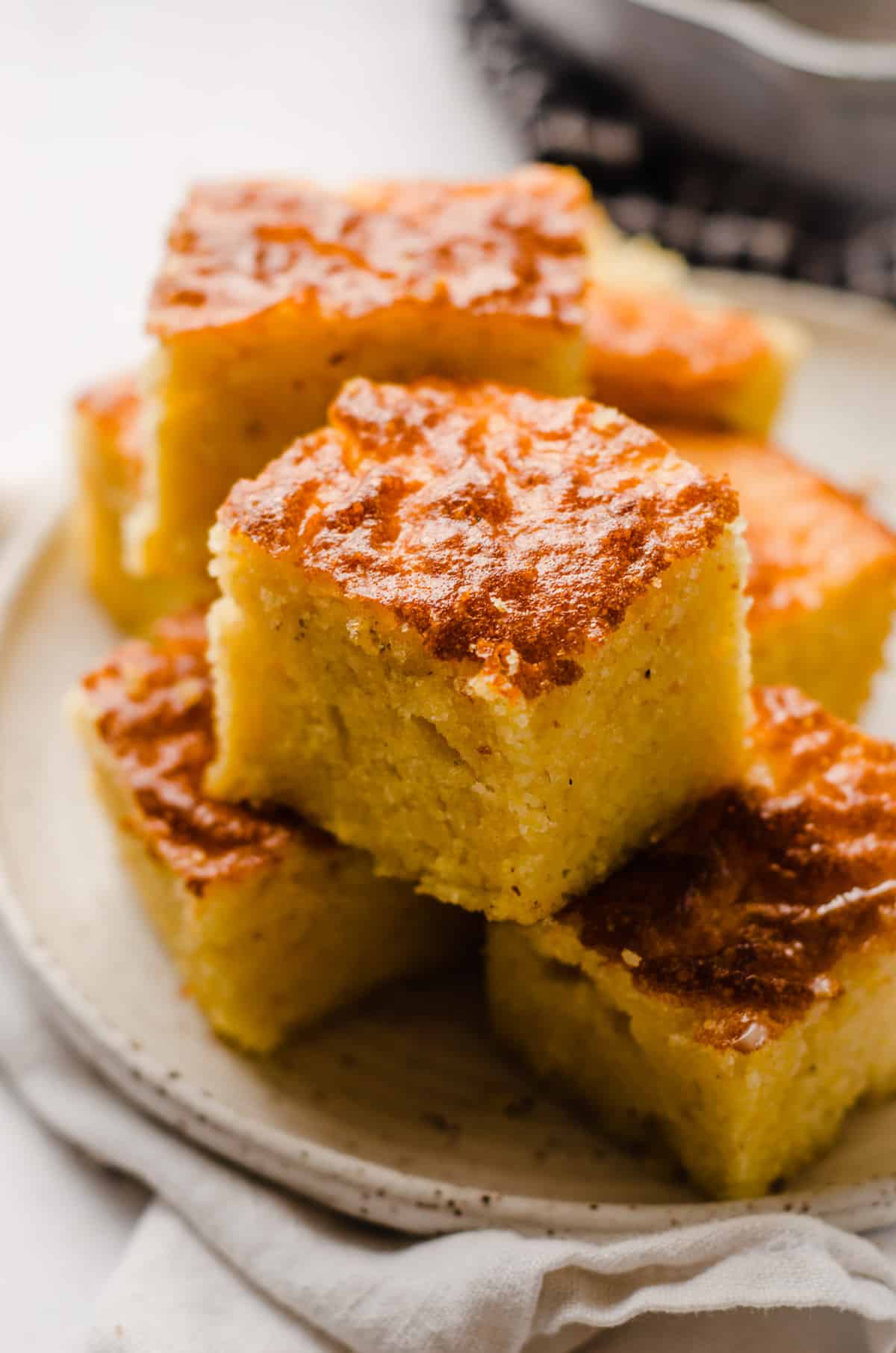 skillet cornbread sliced and on a palte