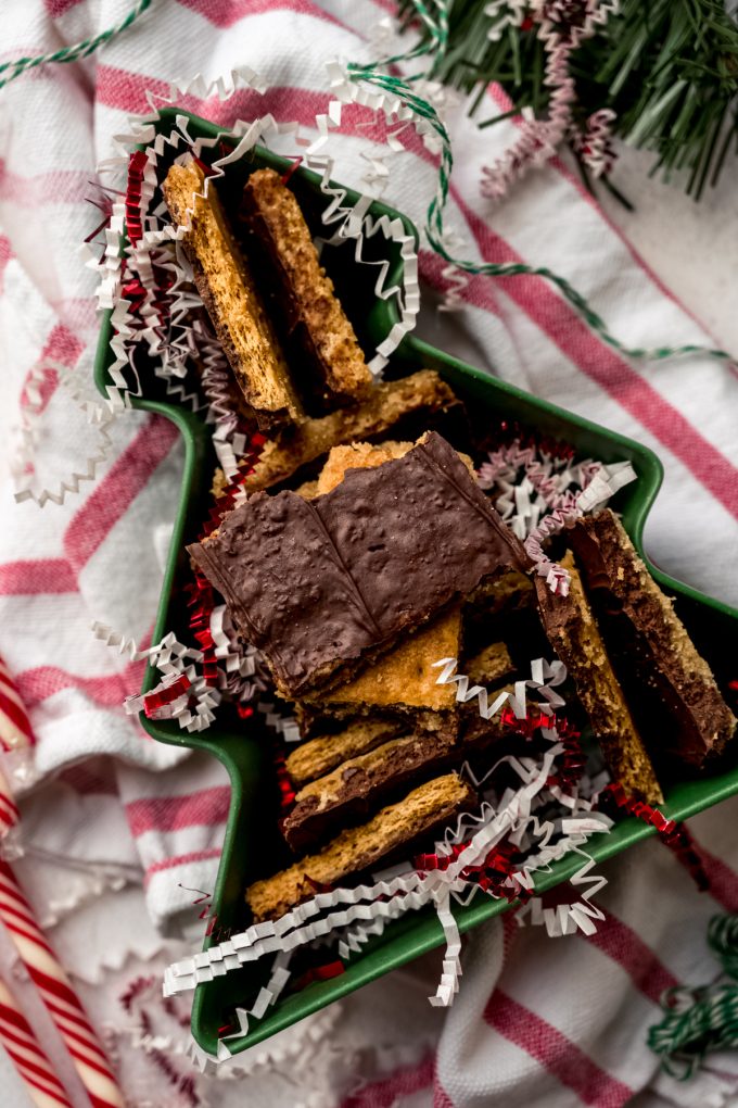 Aerial photo of pieces of graham cracker toffee bark in a tree shaped container.