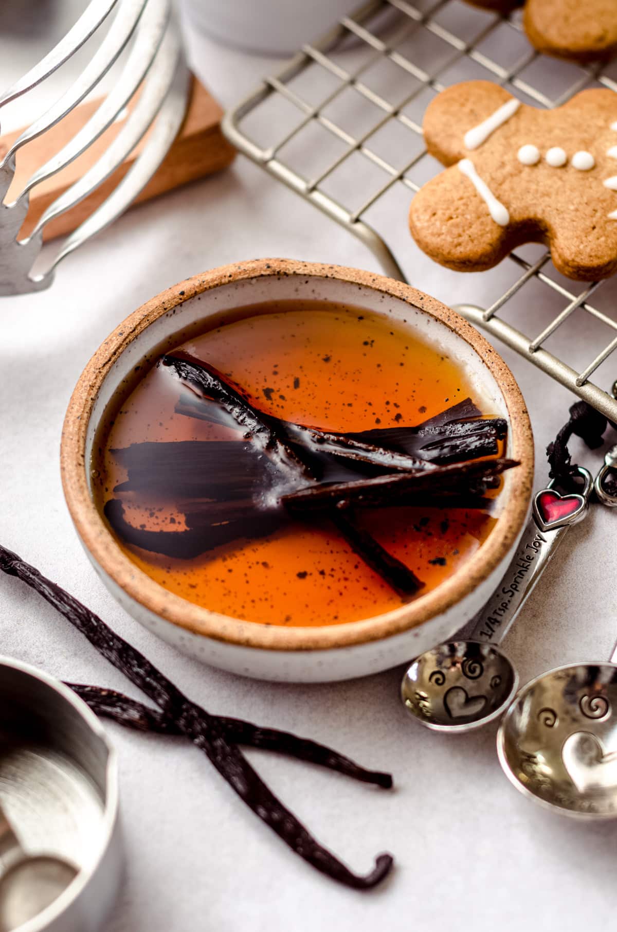 aerial photo of bowl of vanilla extract with vanilla beans in it