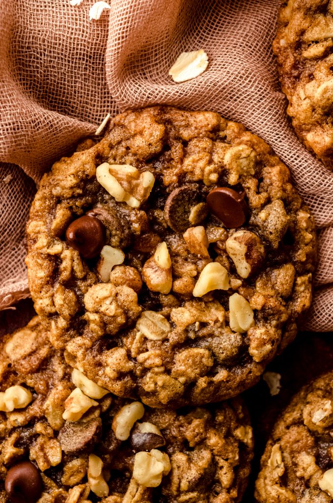 Oatmeal walnut chocolate chip cookies on a surface.