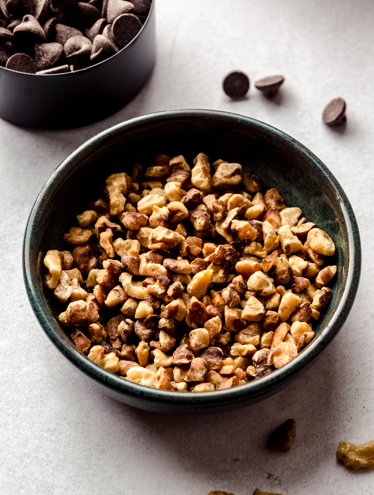 A bowl of toasted walnuts to make oatmeal walnut chocolate chip cookies.