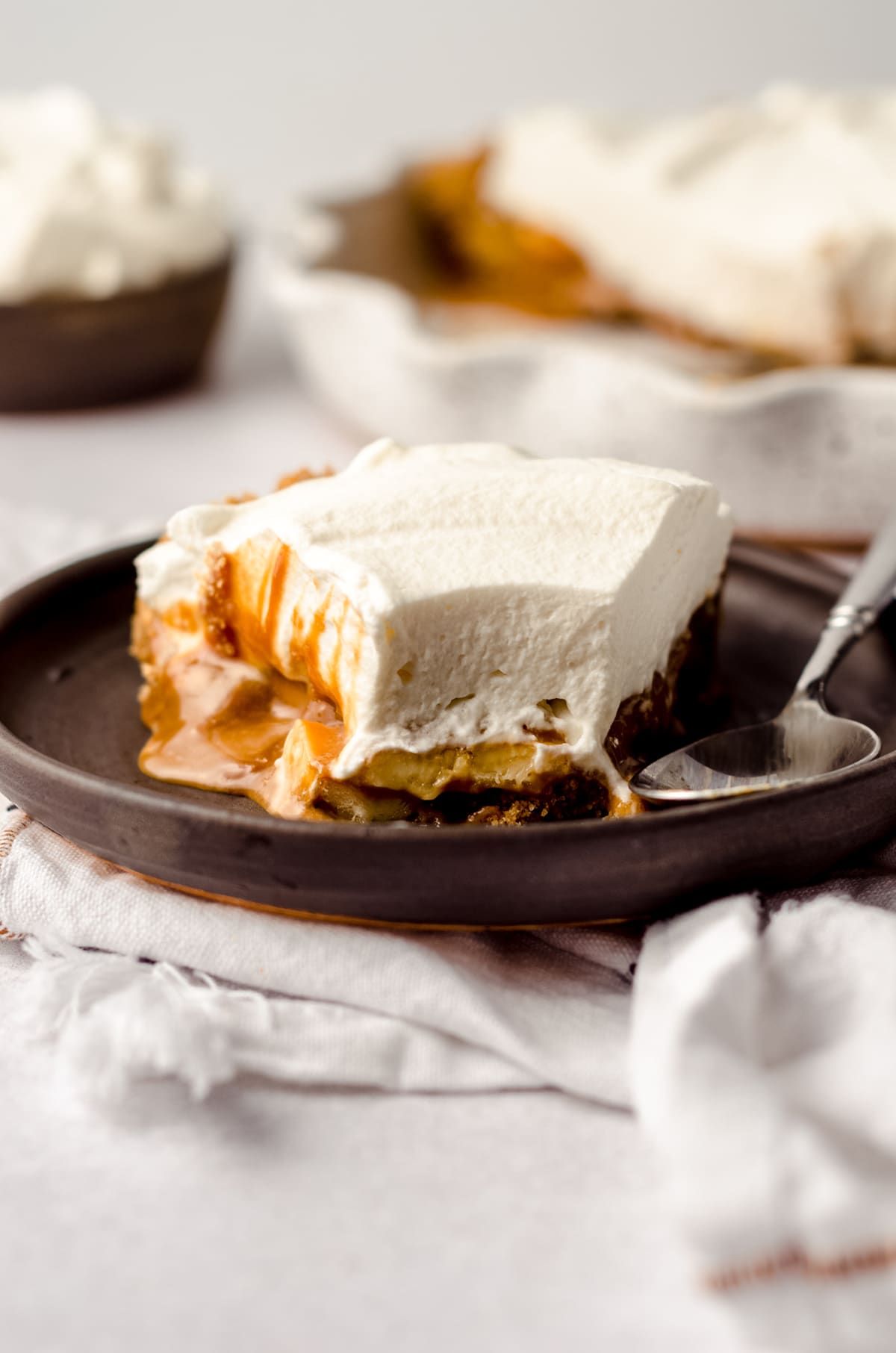 slice of banoffee pie on a plate with a bite taken out of it