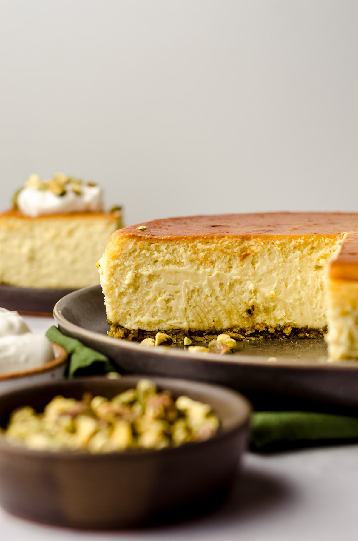 side view of sliced pistachio cheesecake