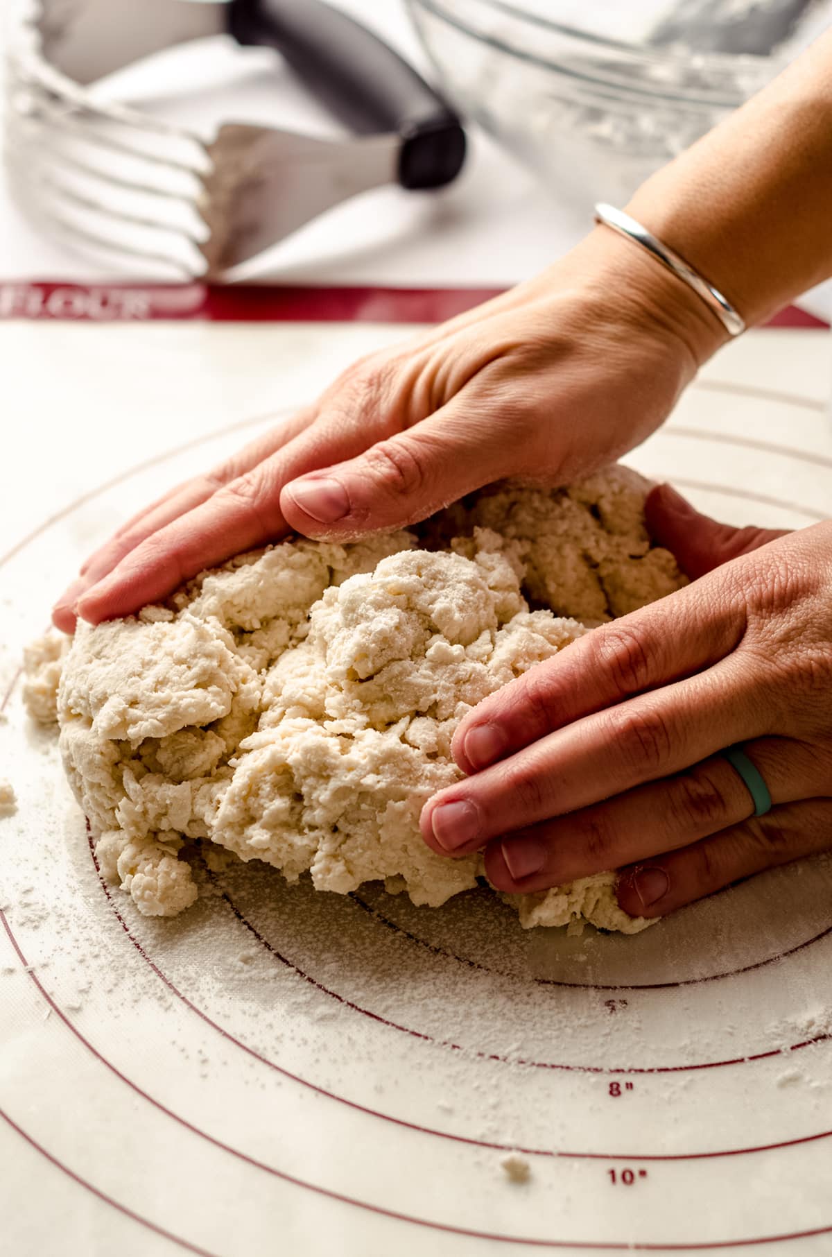 hands shaping biscuit dough