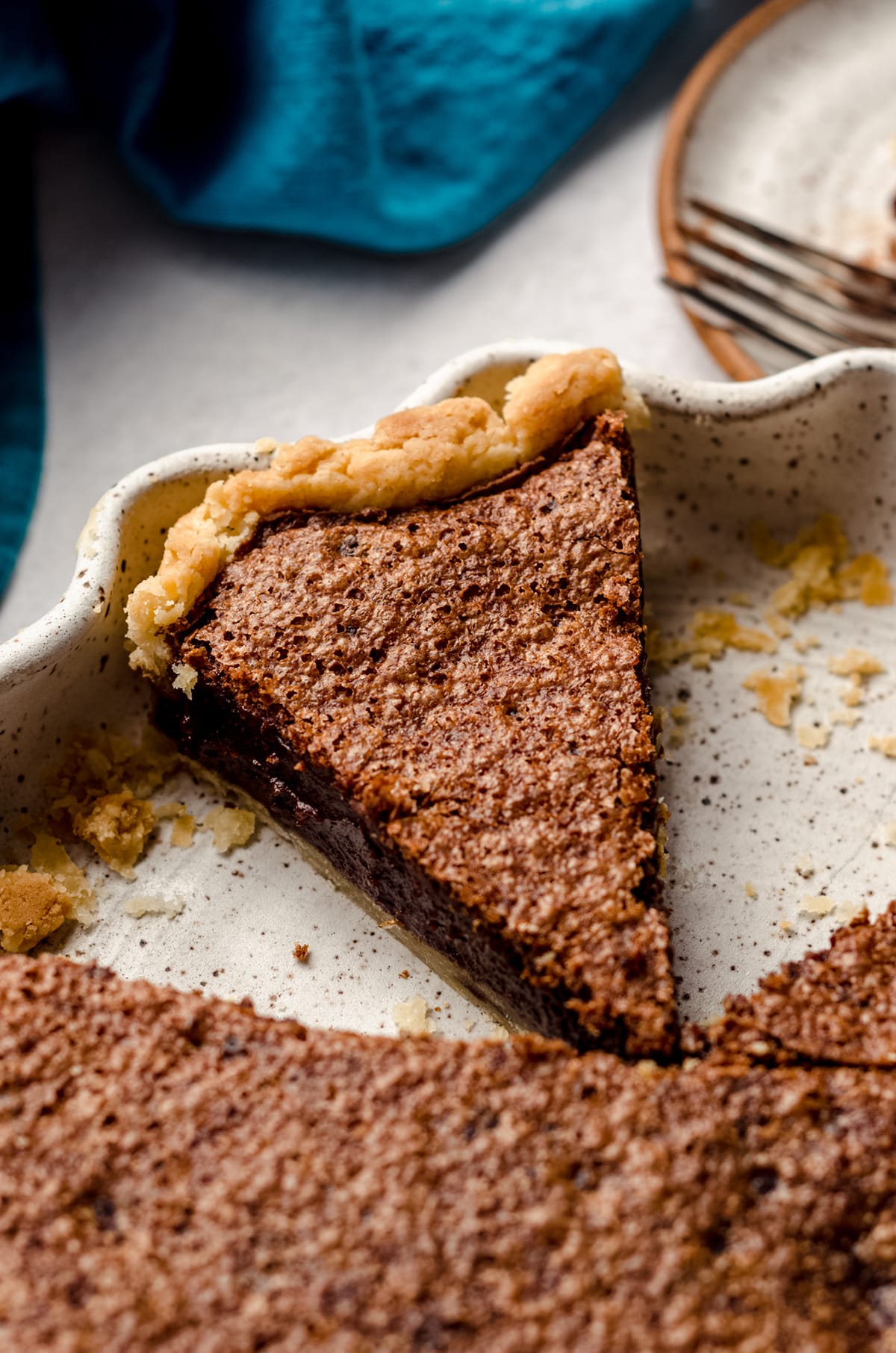 sliced chocolate chess pie in a pie plate