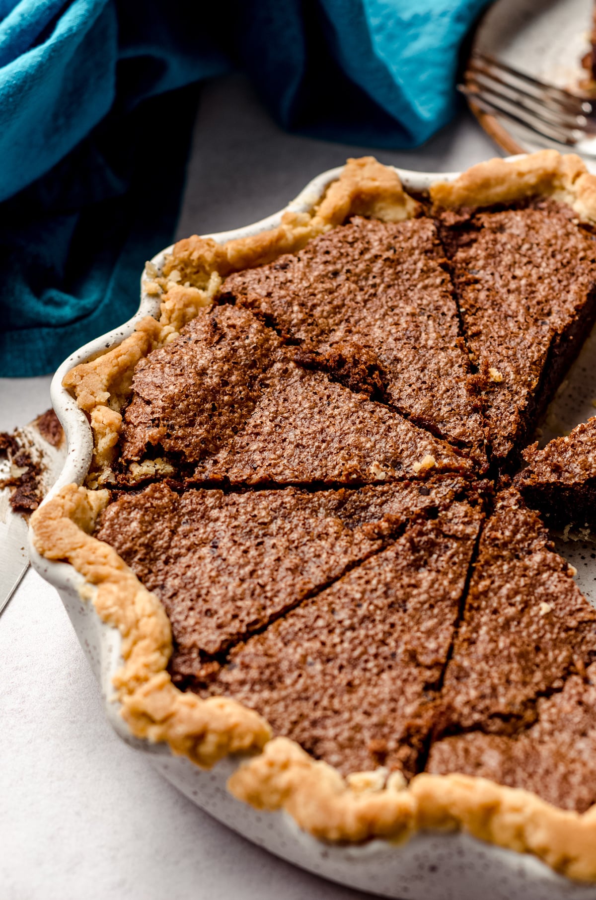 sliced chocolate chess pie in a pie plate