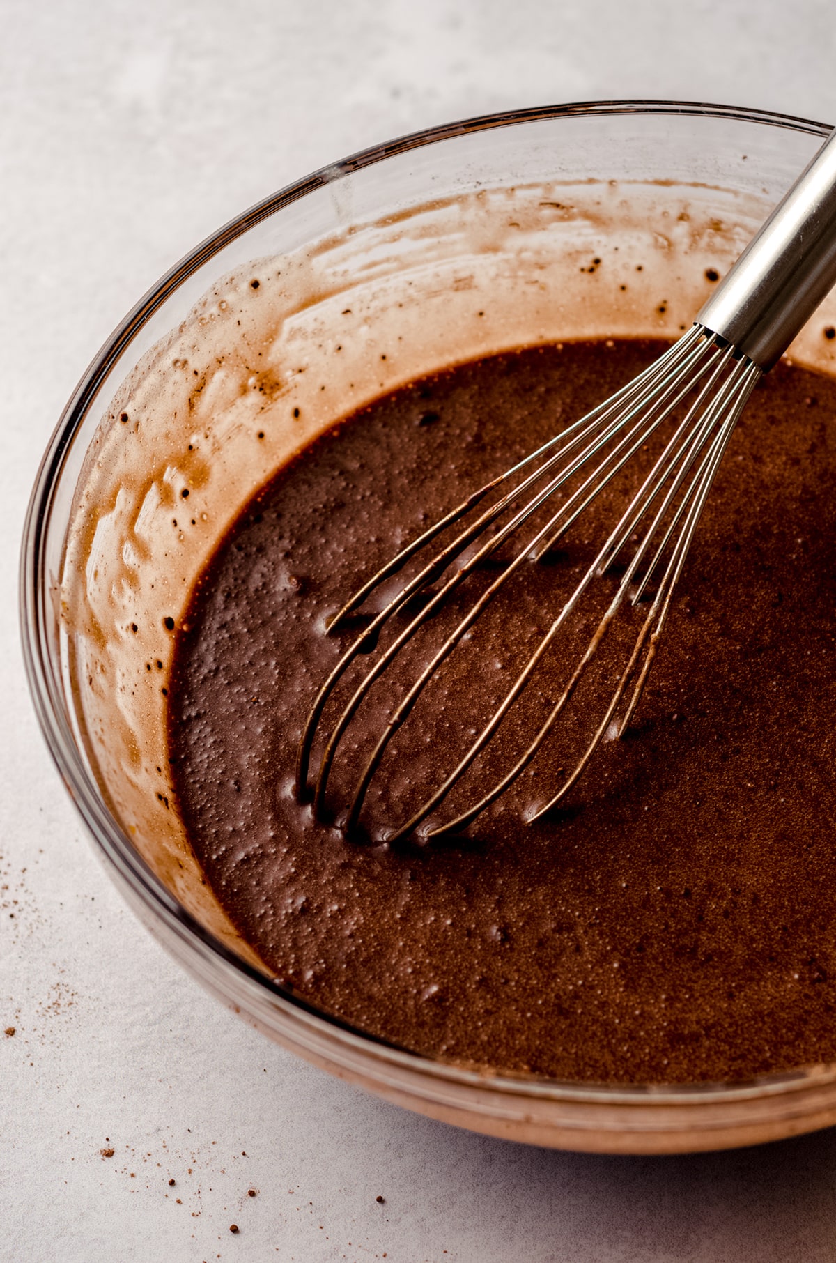 chocolate chess pie filling in a glass bowl with a whisk