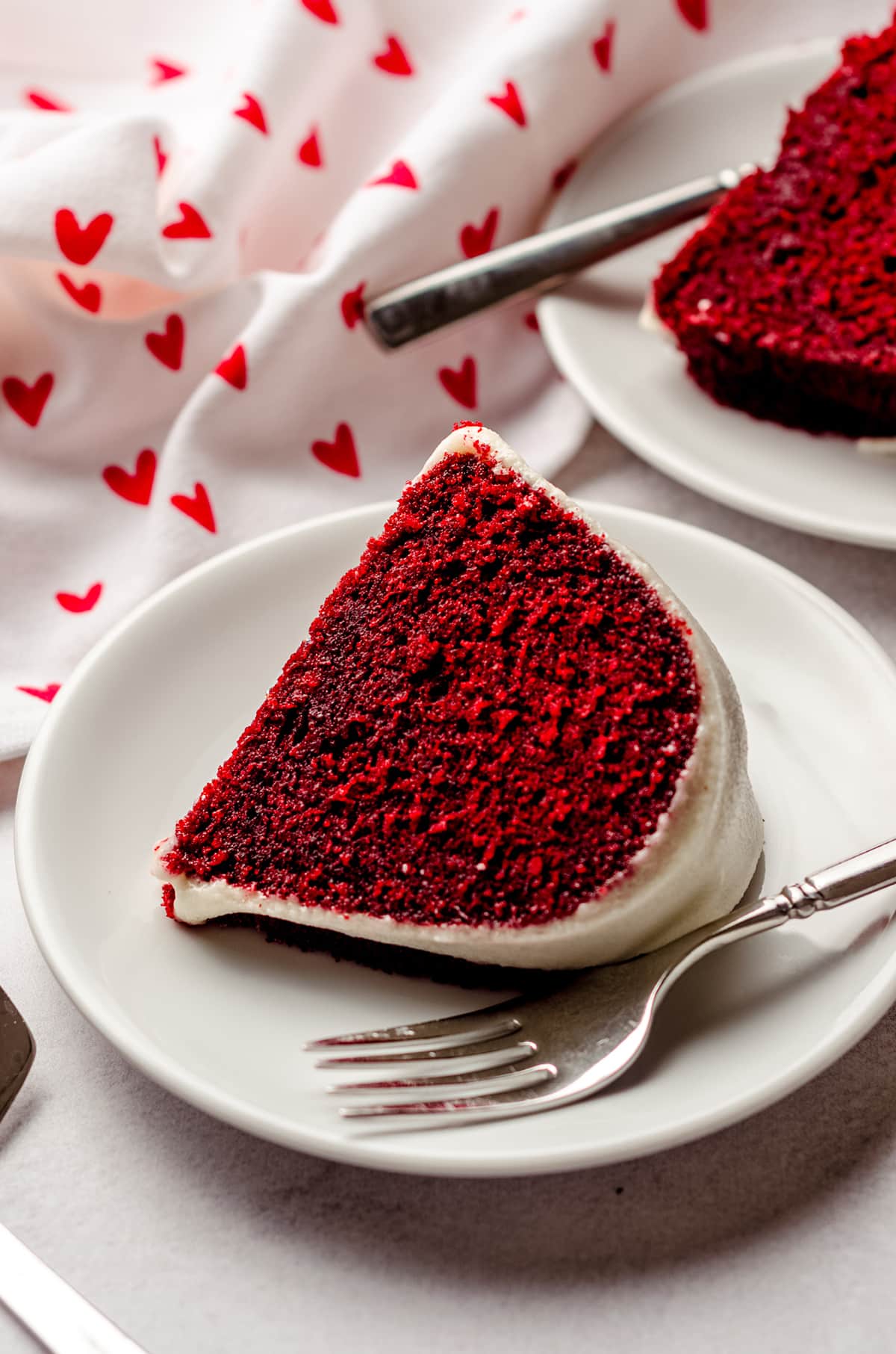 slice of red velvet bundt cake on a plate with a fork