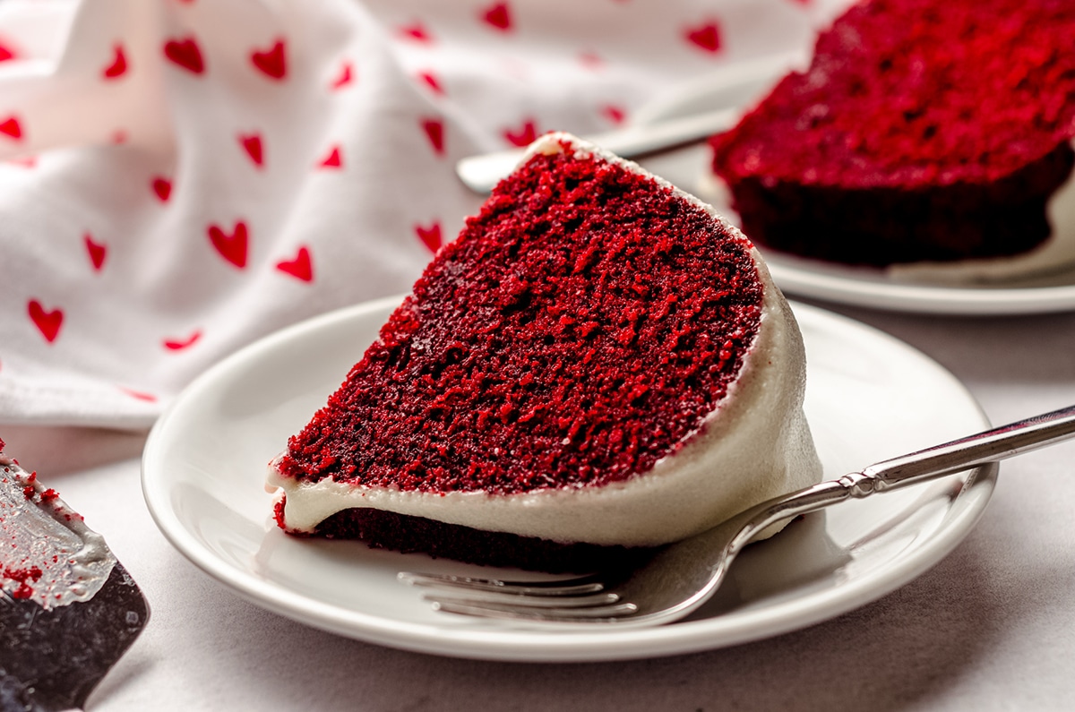 slice of red velvet bundt cake on a plate with a fork