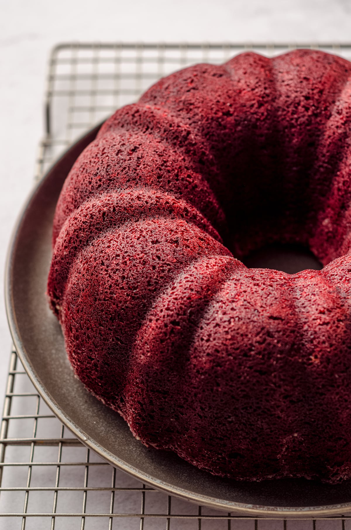 red velvet bundt cake cooling on a cooling rack