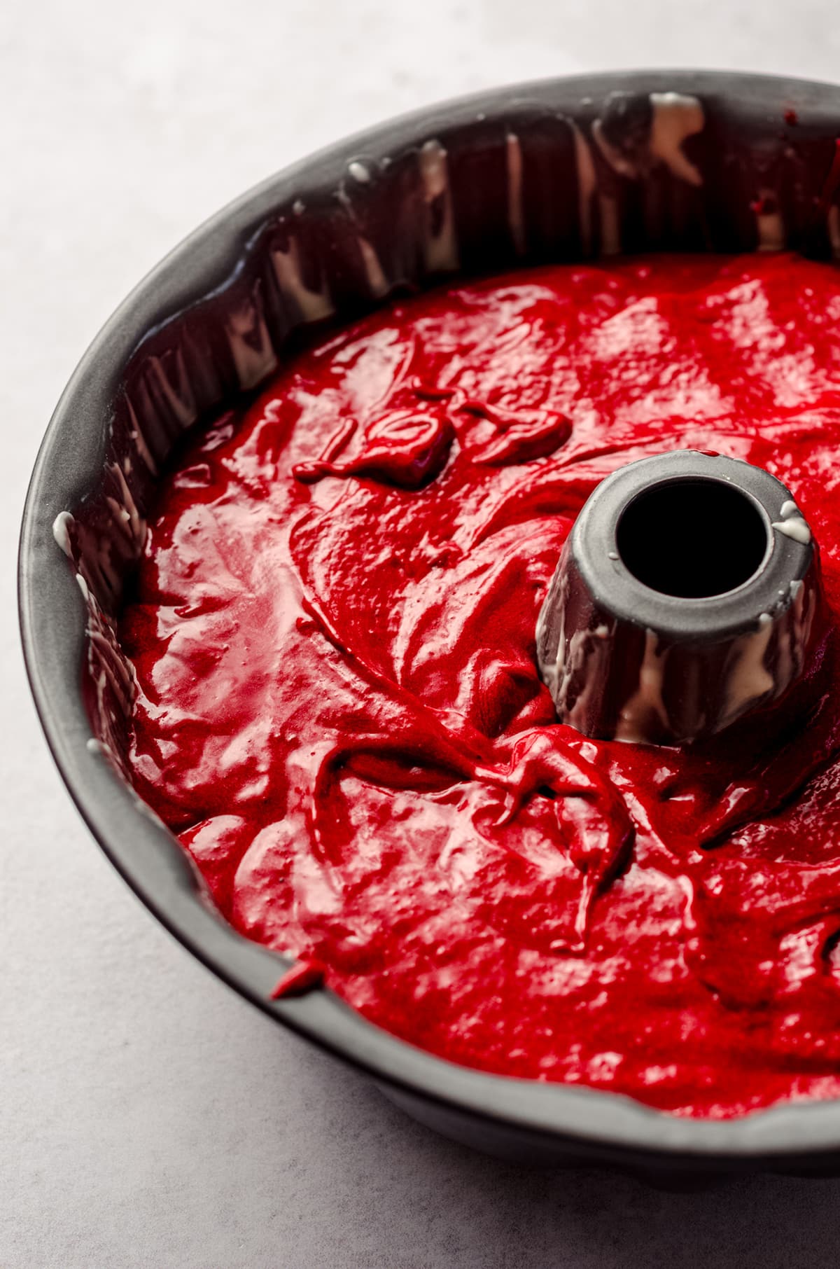 red velvet cake batter in a bundt pan