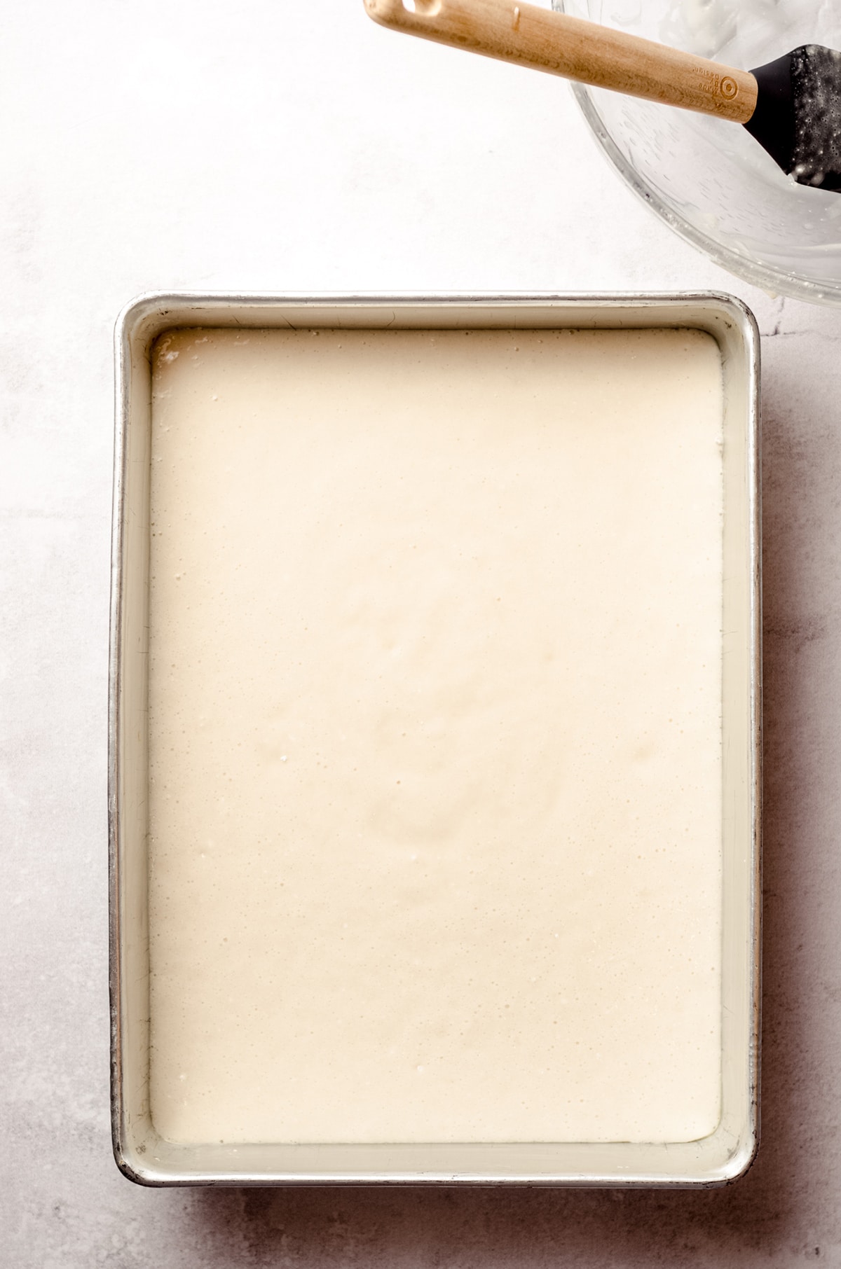 batter for white sheet cake in a pan