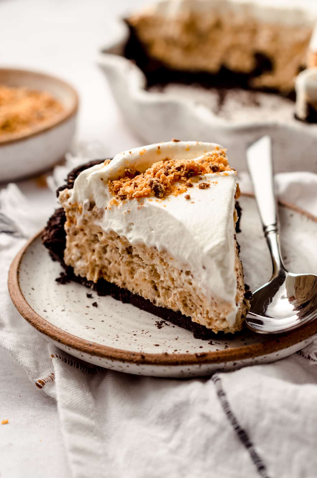 slice of butterfinger pie on a plate with a spoon