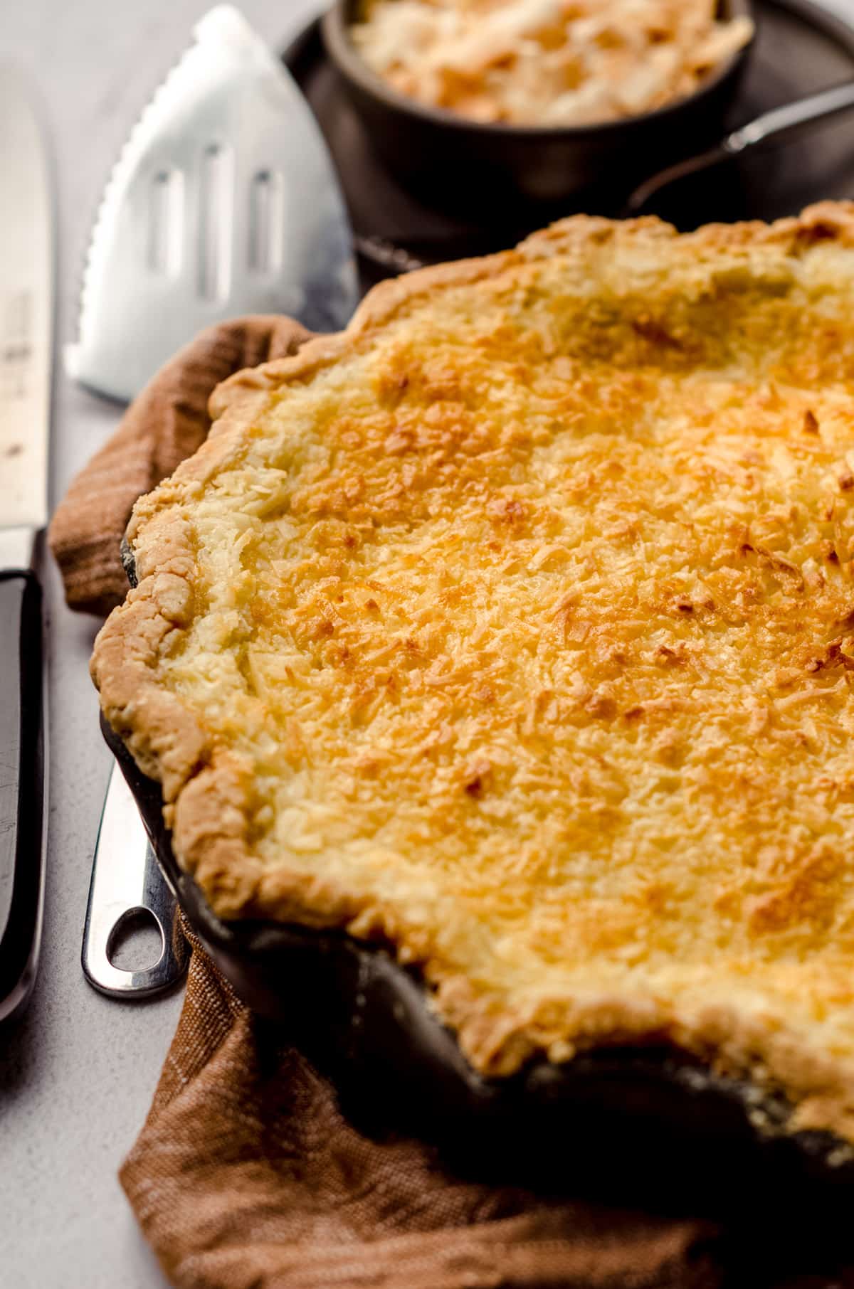 A fully baked pie, topped with shredded coconut.