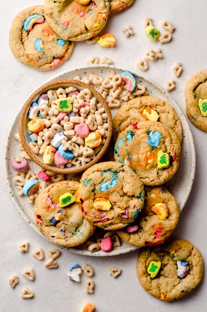 aerial photo of lucky charms cookies on a plate with a small bowl of lucky charms