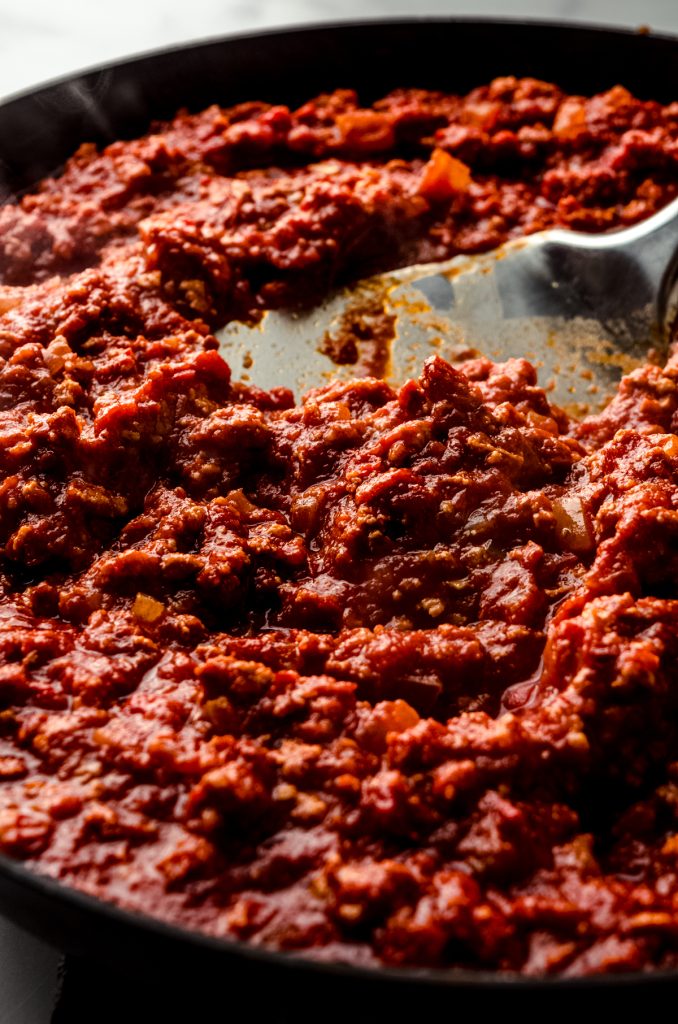 Homemade meat sauce in a saucepan with a large spatula.