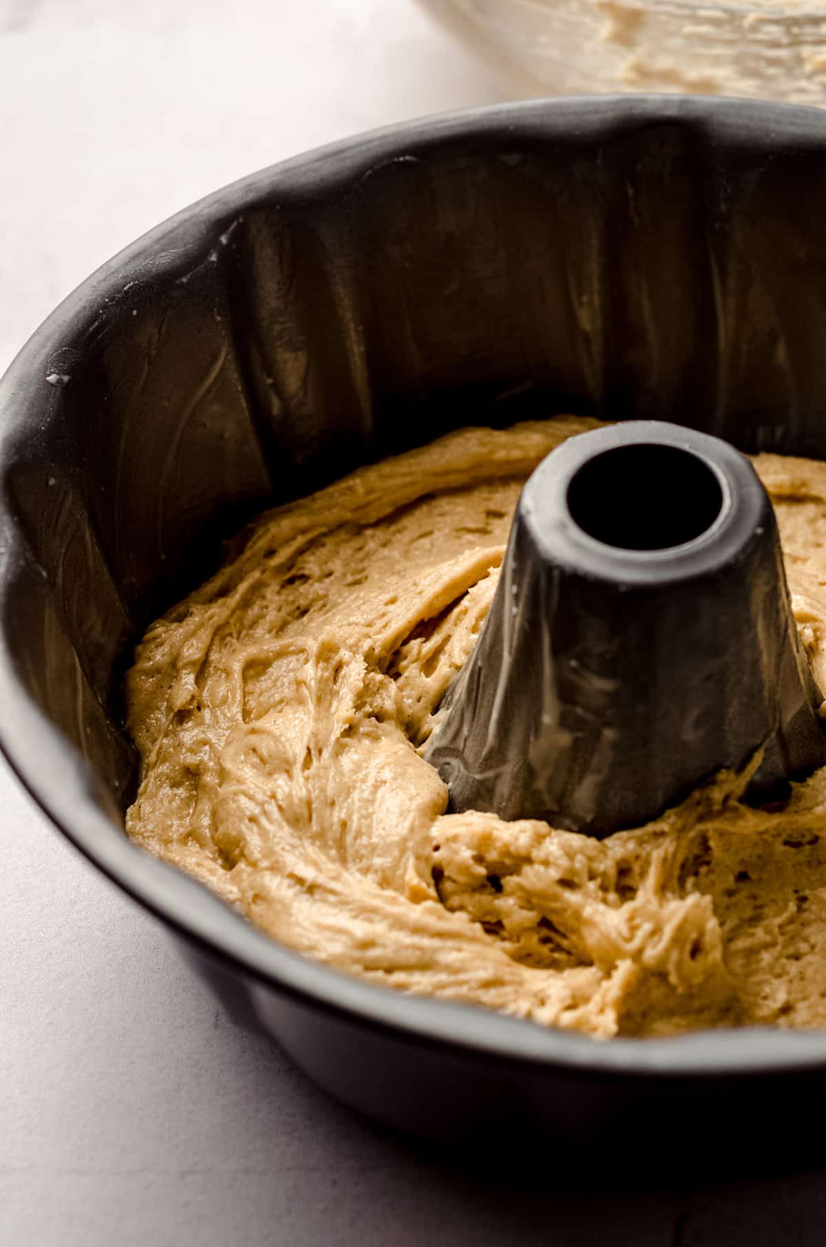 cinnamon streusel coffee cake batter in a bundt pan