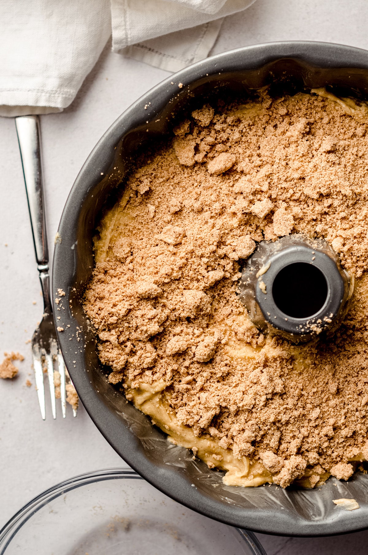 aerial photo of cinnamon streusel coffee cake in a bundt pan ready to bake