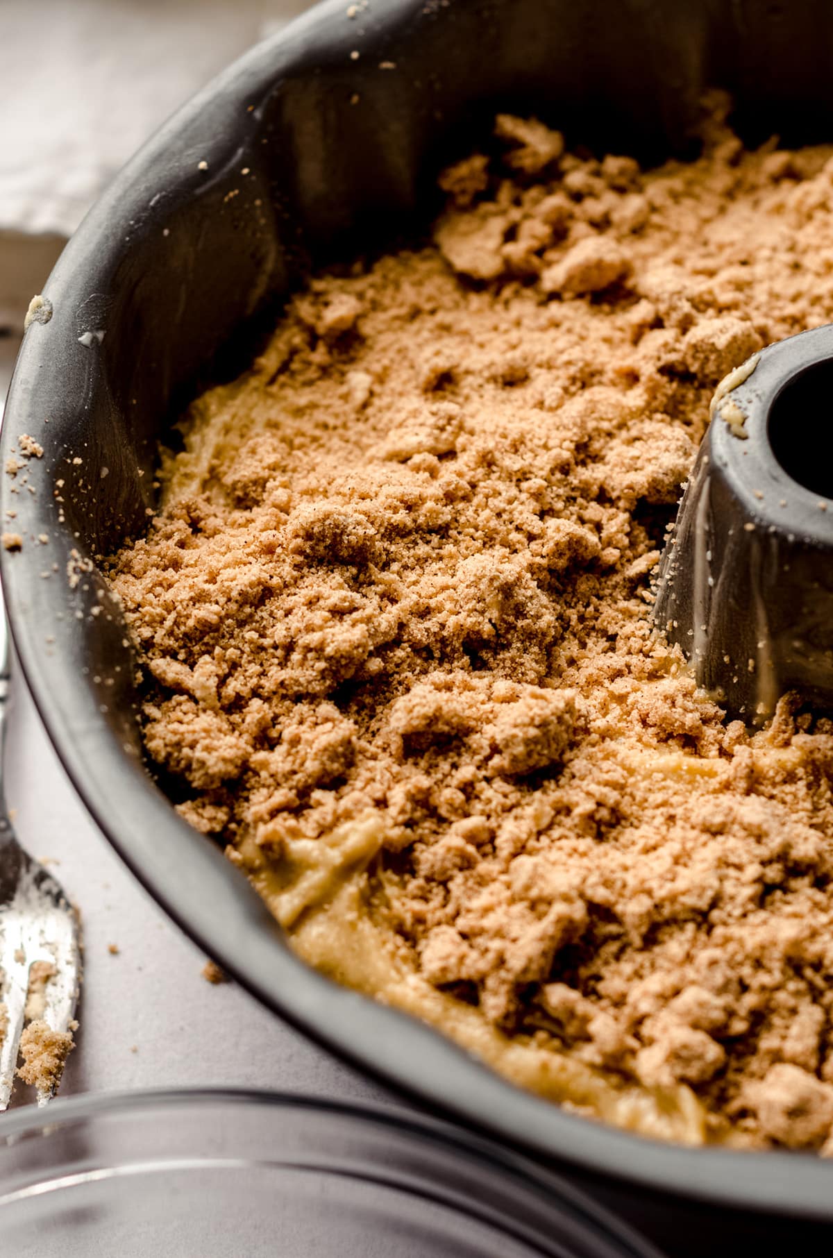 closeup of cinnamon streusel topping on coffee cake batter in a bundt pan