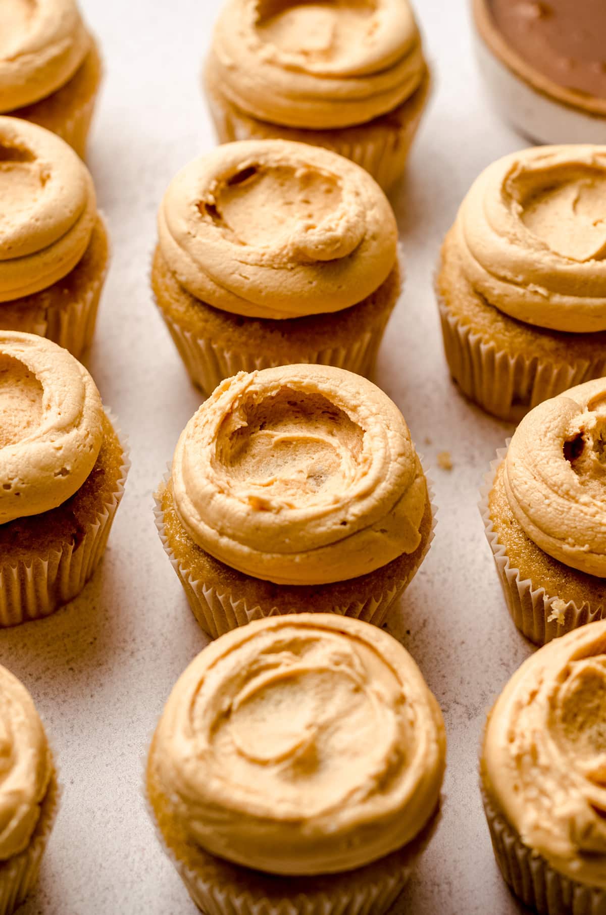 Cupcakes topped with dulce de leche buttercream, with the center dipped in.