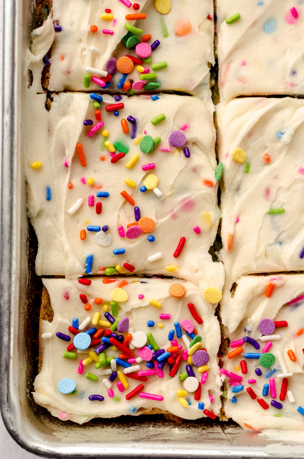 An overhead shot of squares of funfetti sheet cake.