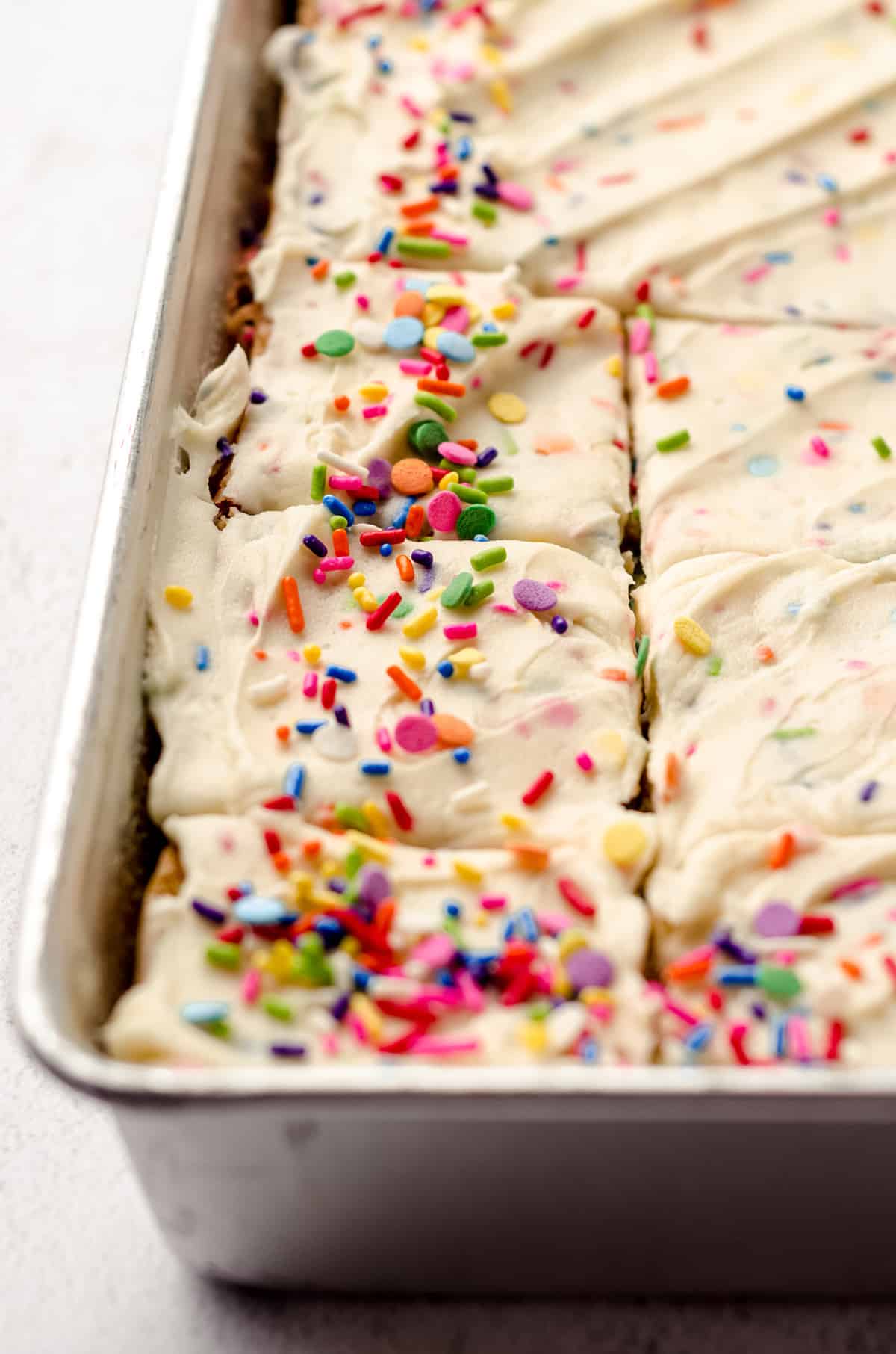 A sheet pan, filled with vanilla and funfetti cake.