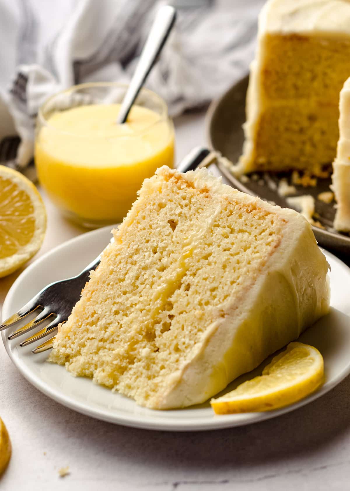 A slice of lemon cake with a lemon curd filling.