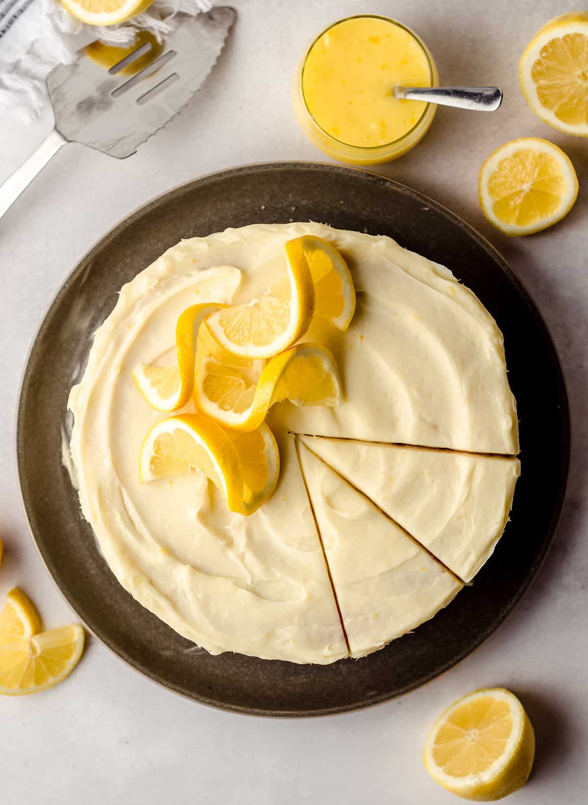 An overhead view of a lemon cake with lemon cream cheese frosting.