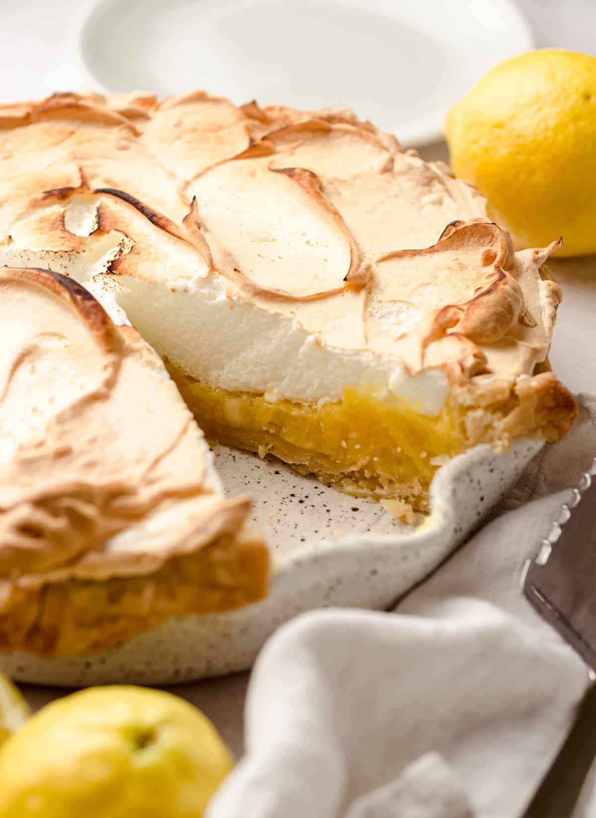 A lemon meringue pie with a slice removed