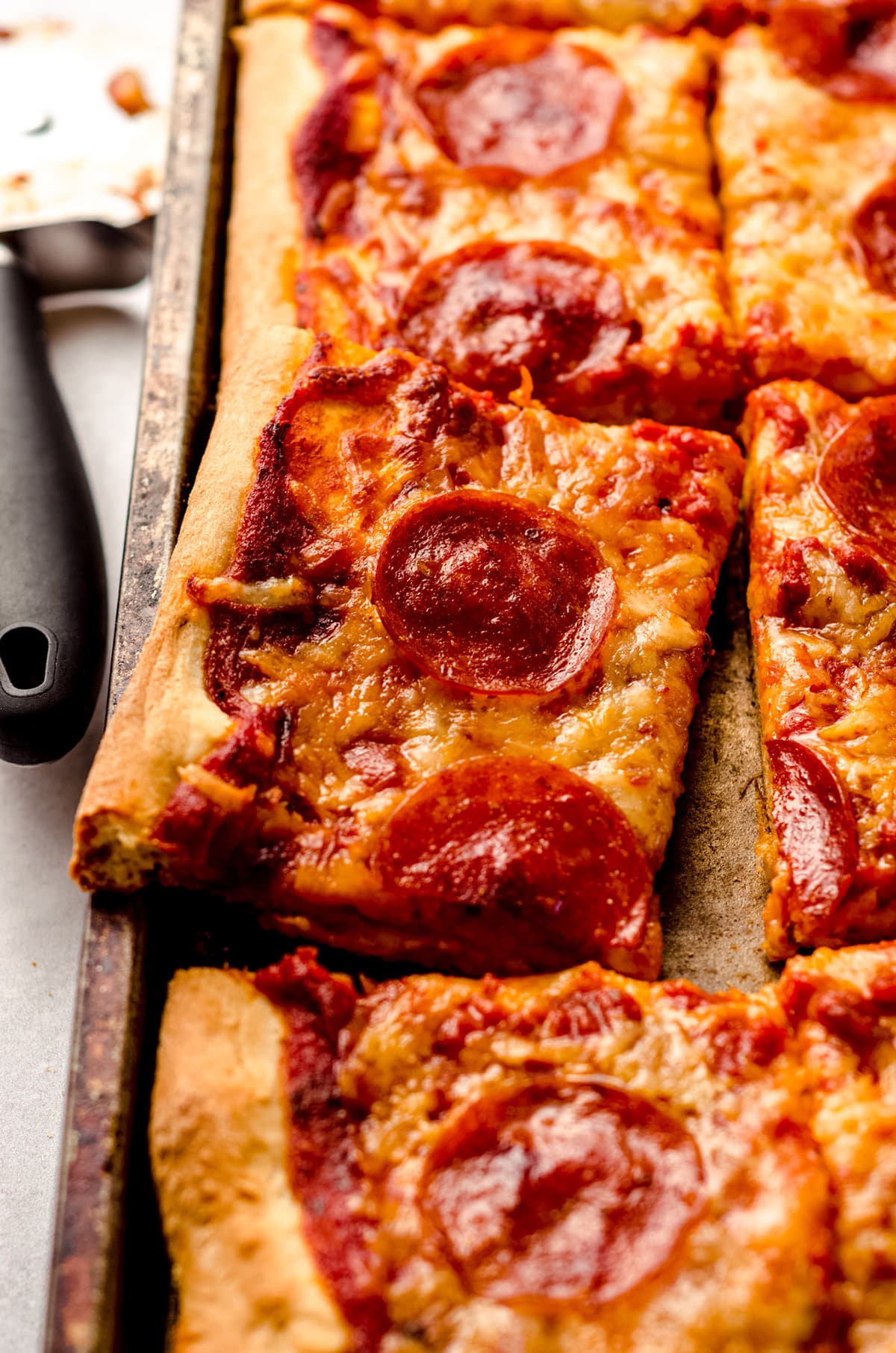 A rectangular homemade pizza baked in a sheet pan.