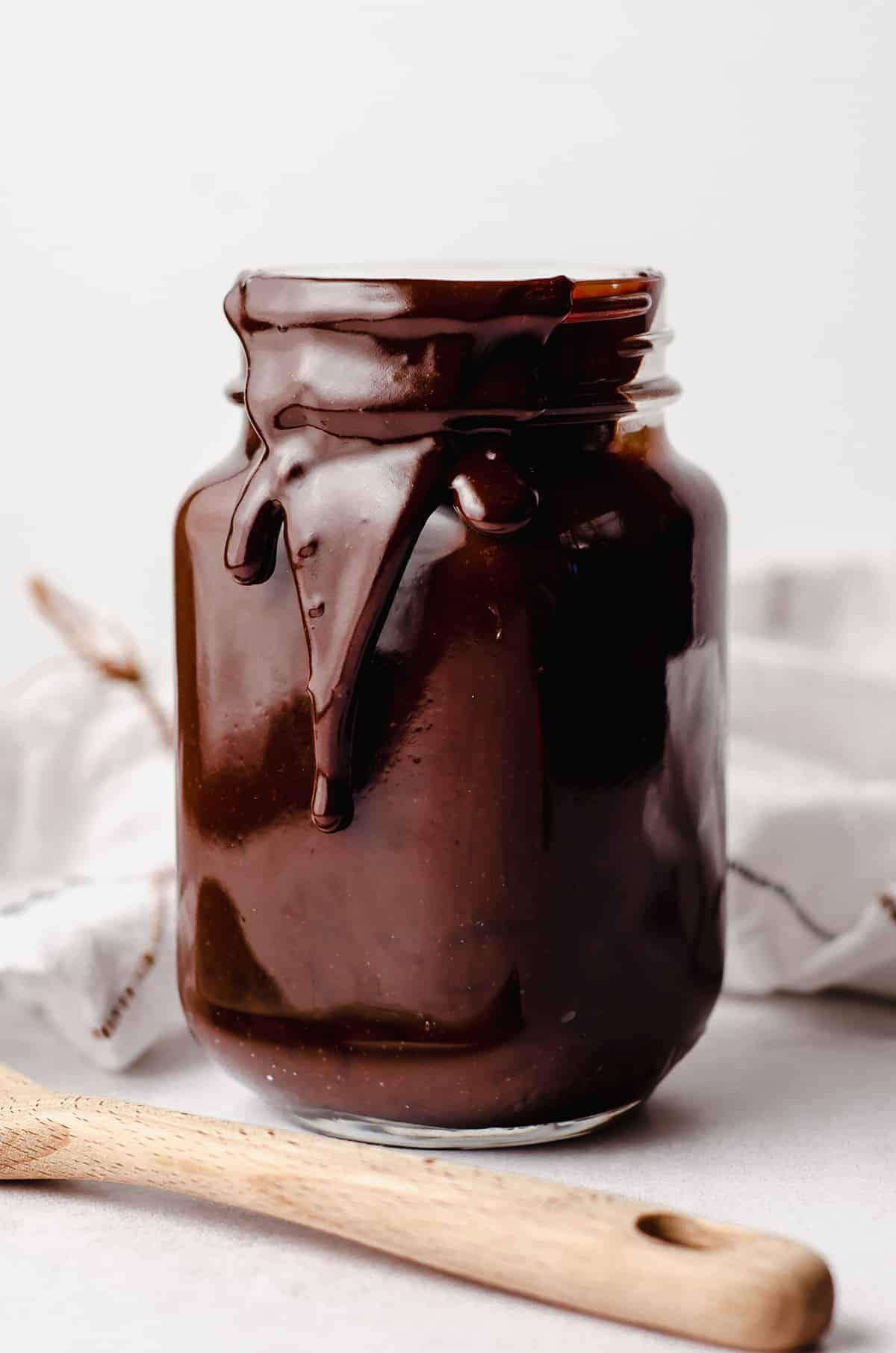 a drippy jar of homemade hot fudge sauce
