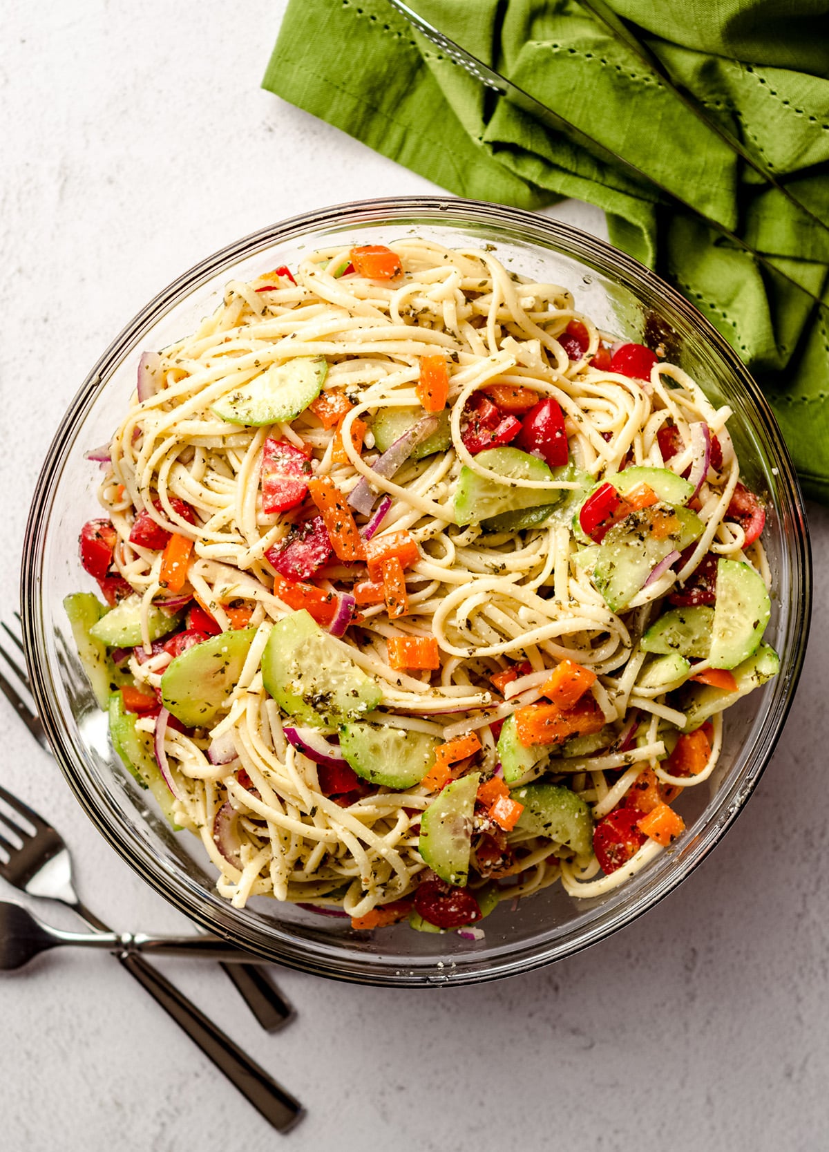 An overhead shot of a large serving bowl of cold spaghetti salad.