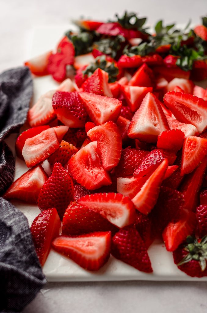 strawberries sliced on a cutting board