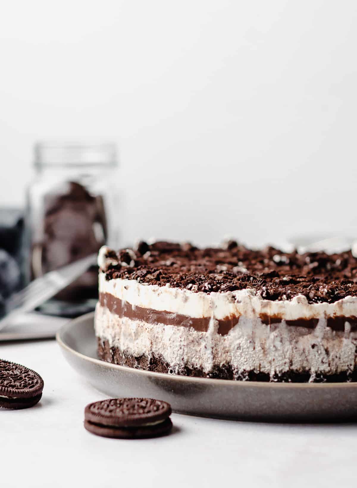 A front on view of a layered ice cream cake made with Oreo cookies.