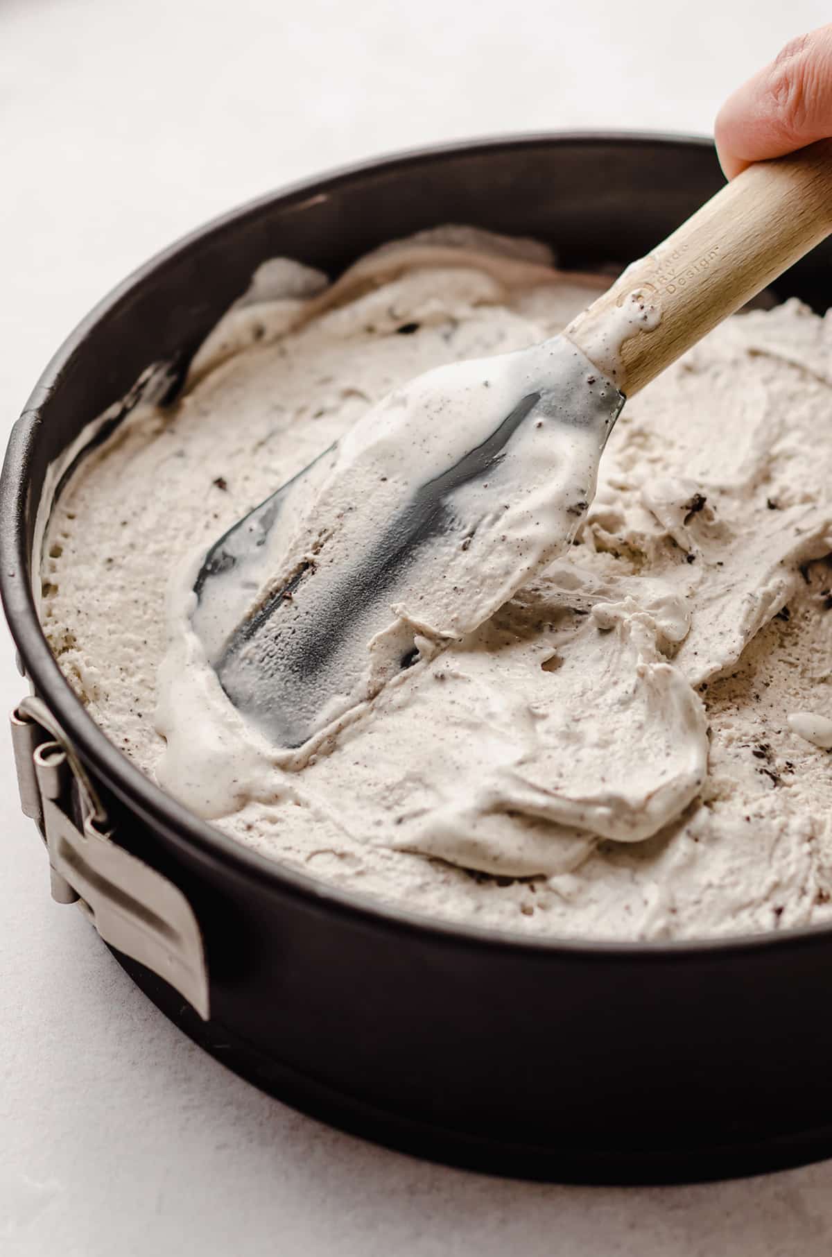 Smoothing ice cream into a springform pan.