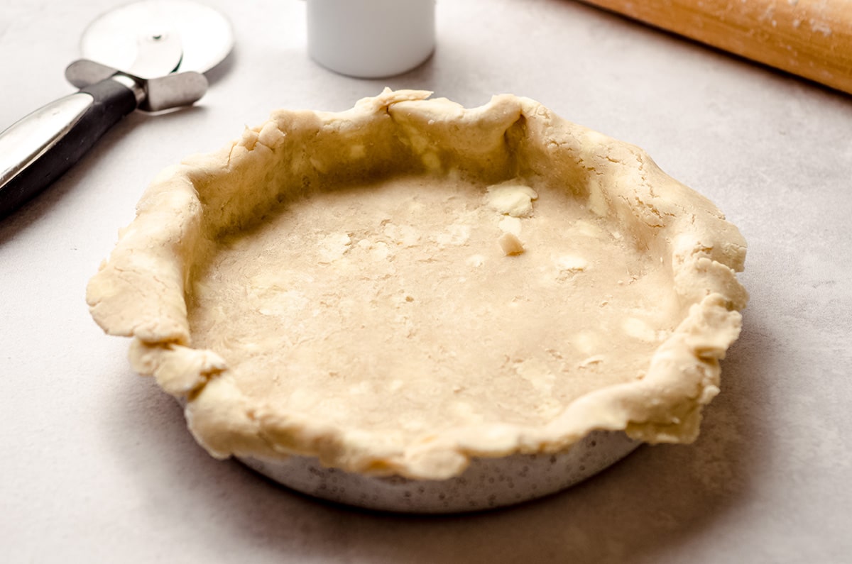 A pie crust fitted into a pie plate.
