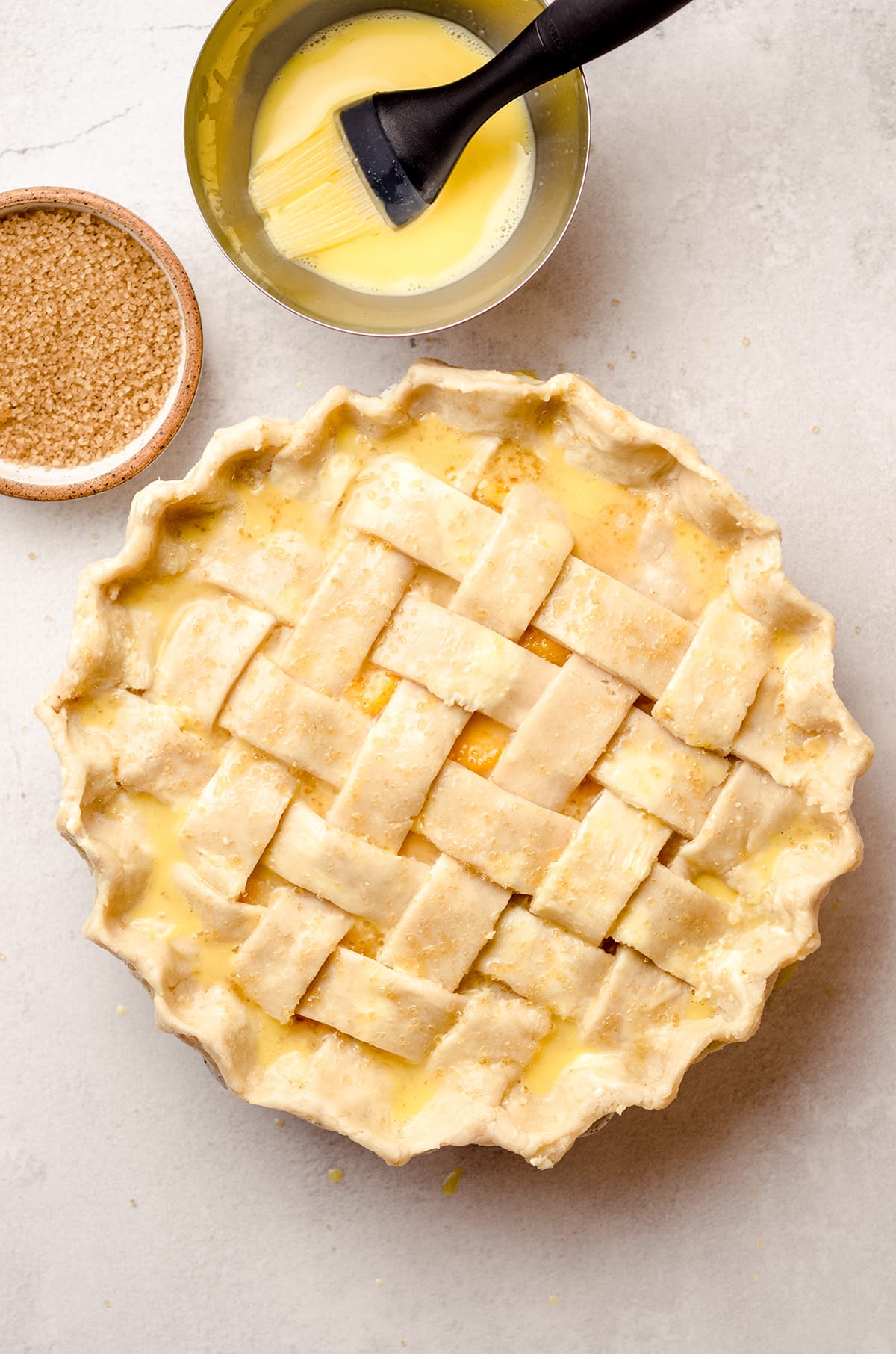 A lattice crust pie, brushed with an egg wash.