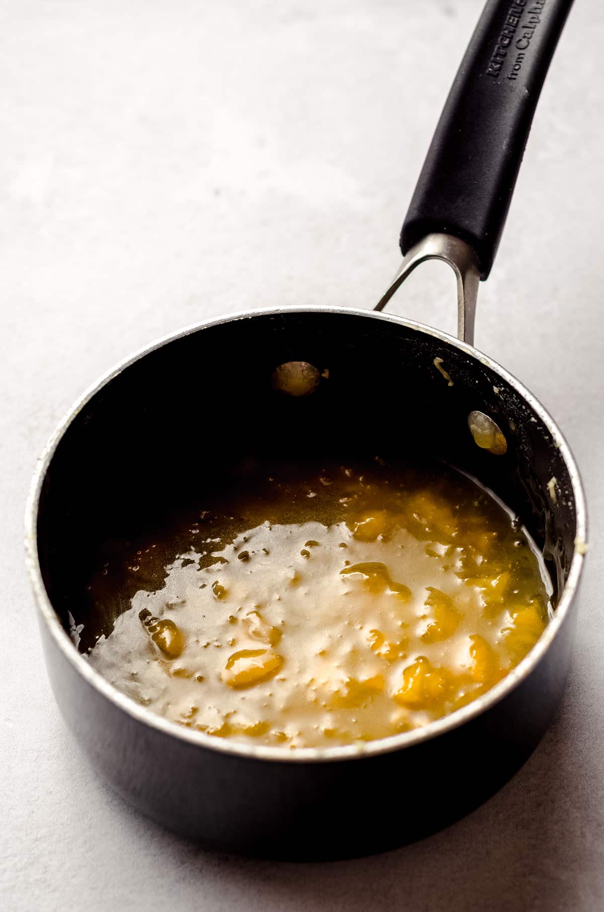A saucepan of reduced peach filling.