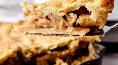 slice of caramelized apple pie on a pie server