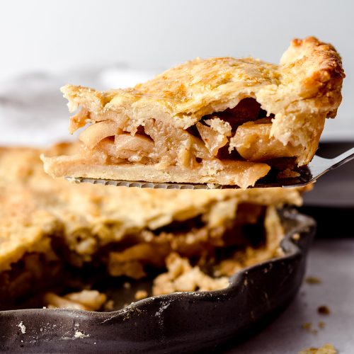 slice of caramelized apple pie on a pie server