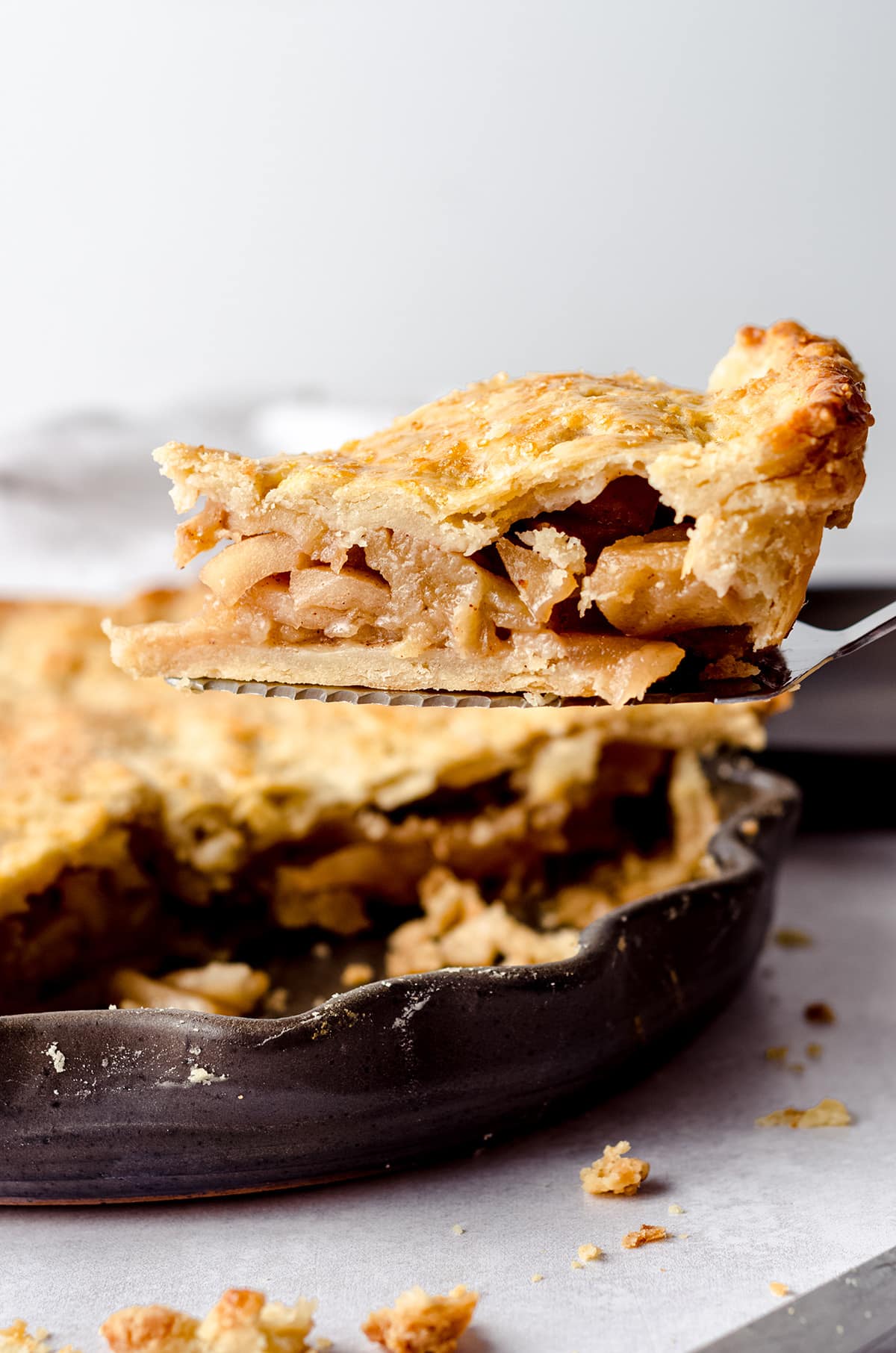 slice of caramelized apple pie on a pie server