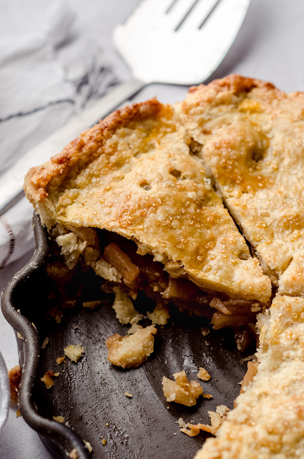 slice of apple pie in a pie dish