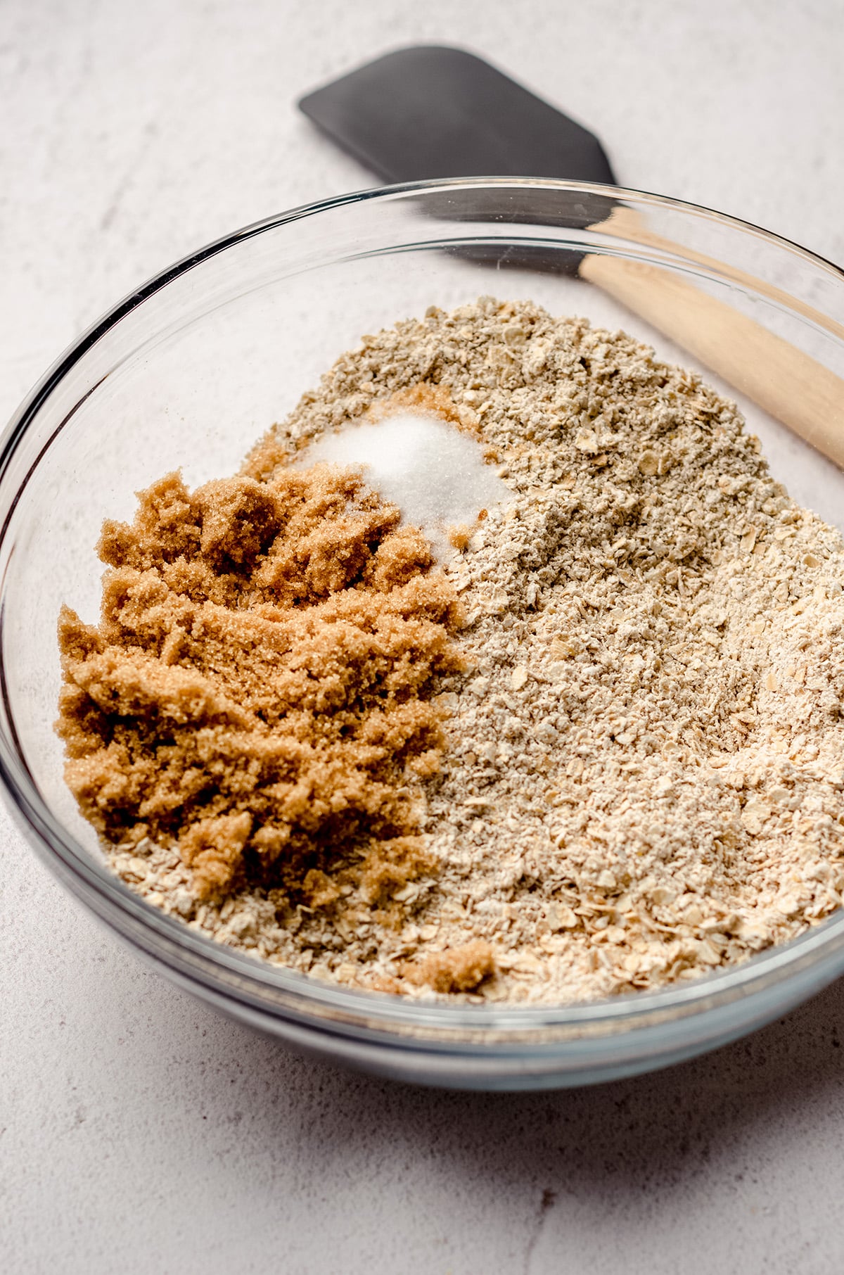 Mixing together oatmeal with brown sugar.