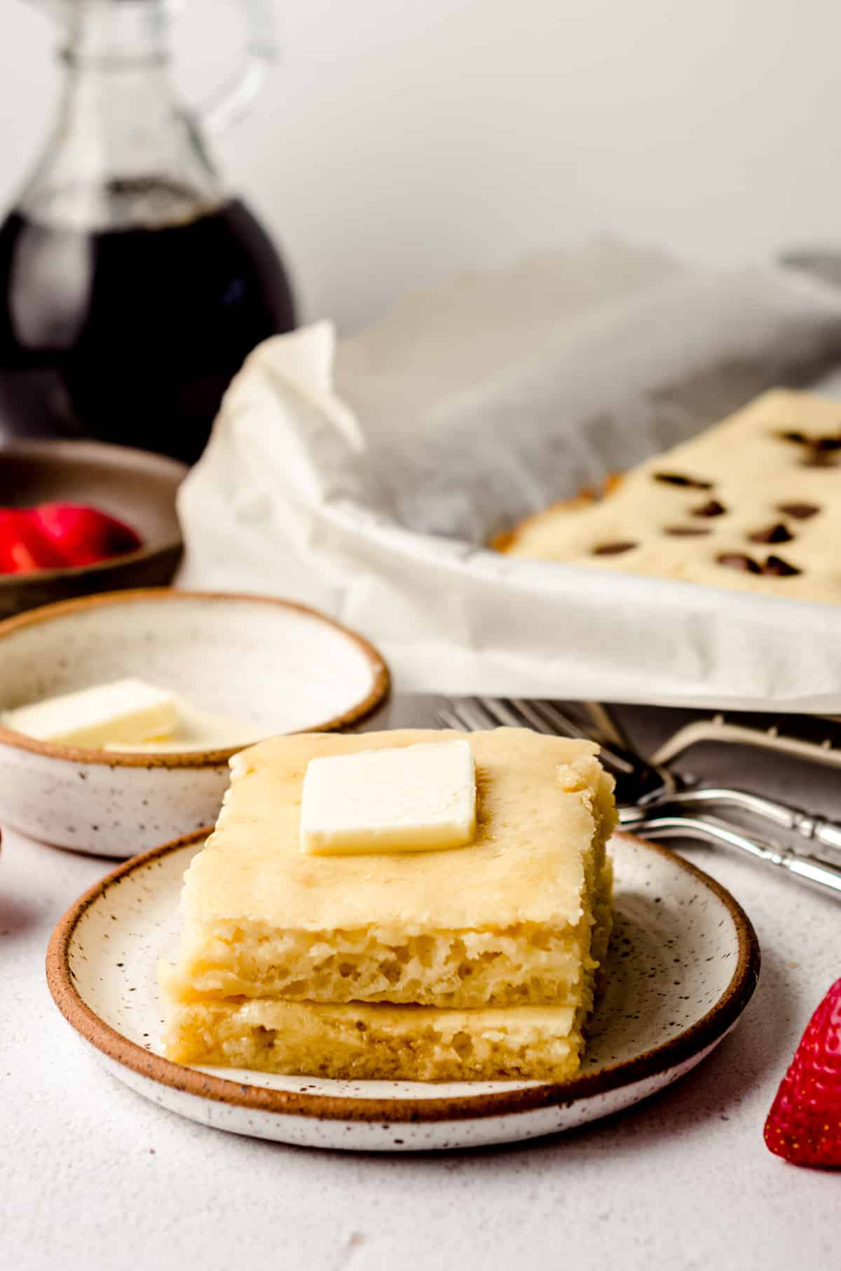 stack of sheet pan pancakes with a pat of butter